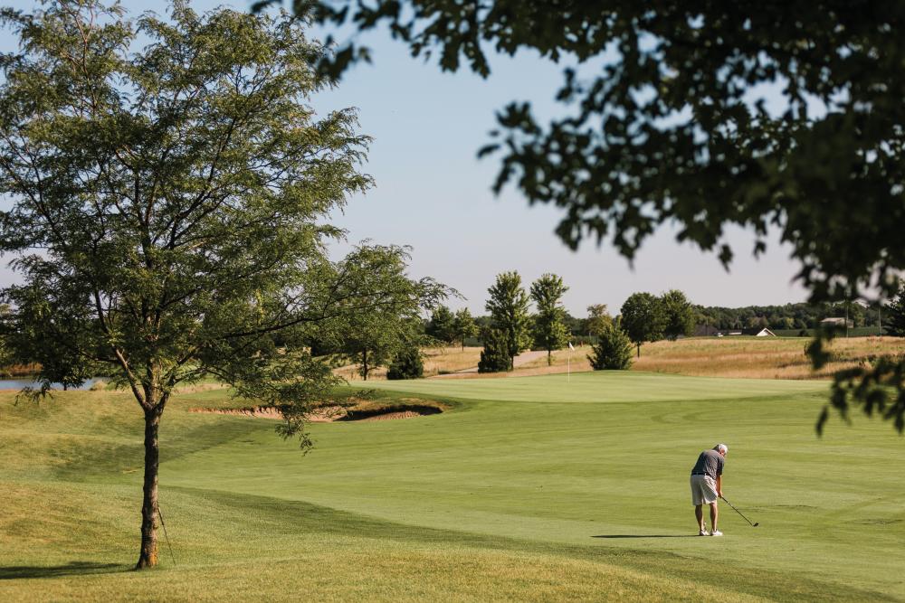 A man golfs at Metatamora Fields Golf Course.