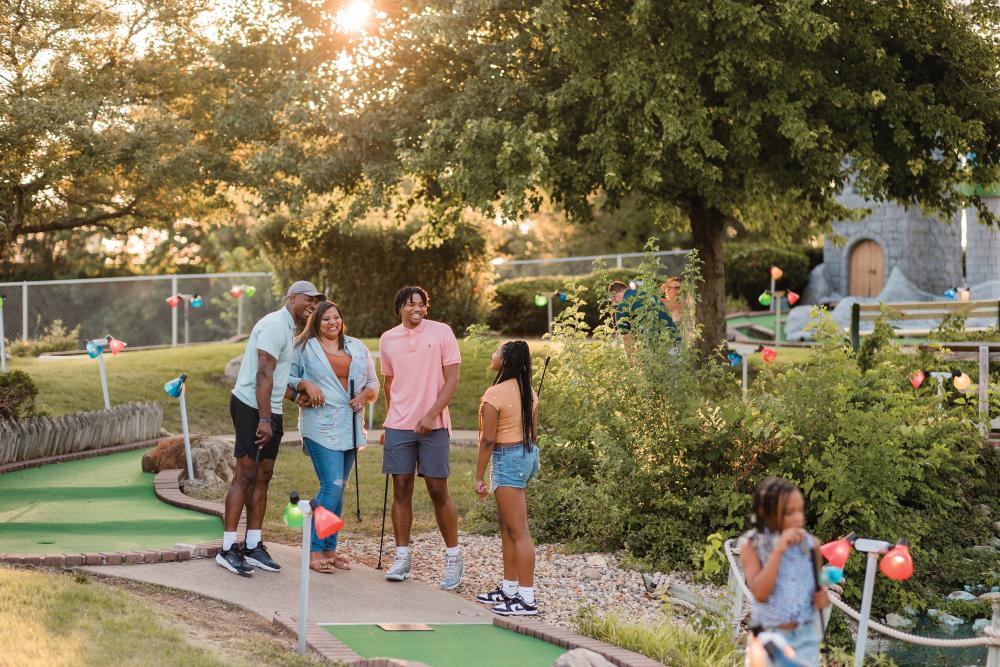 A family plays mini-golf at Mt. Hawley Castle Golf.