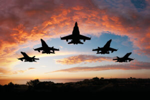 Five Okaloosa County military fighters flying at sunset
