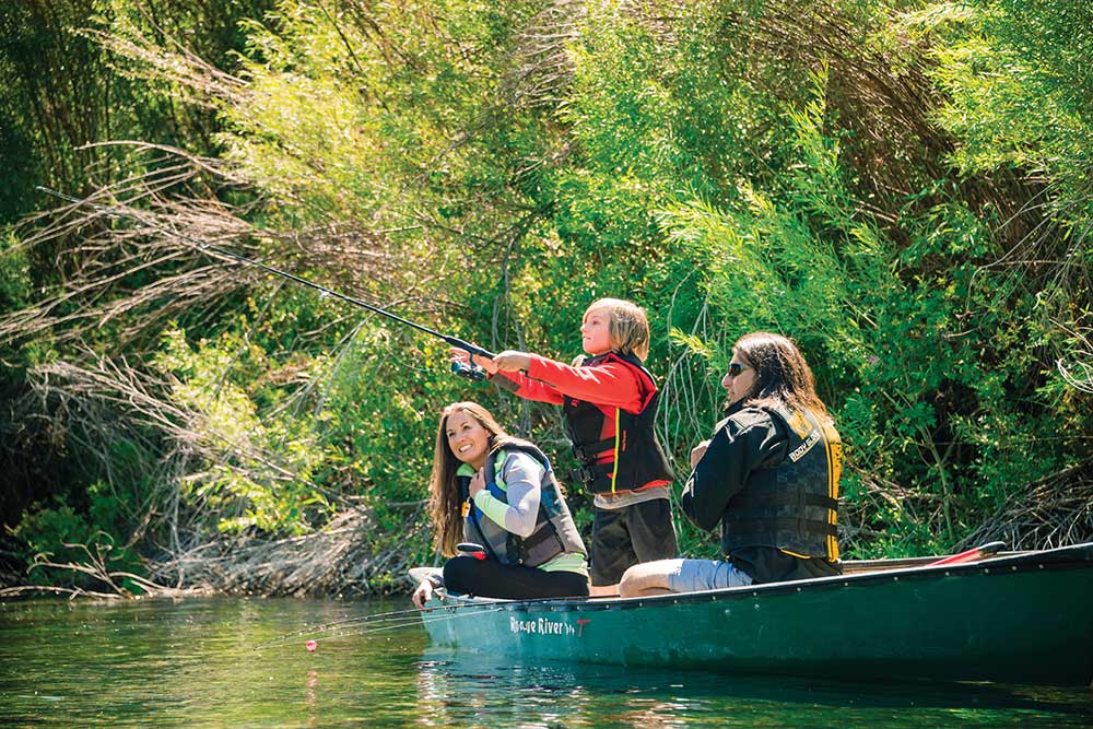 A woman on a canoe with two young children at the Thousand Springs State Park.