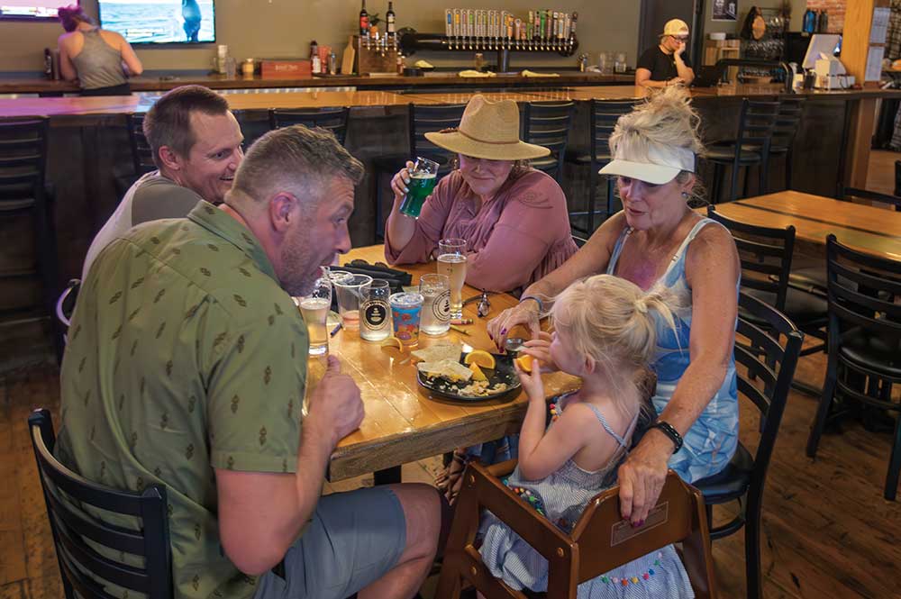Steve McRae, front right, talks with his daughter Libby as he and his wife Kathy, behind right, visit with Kelly Skelley, front right, and Dris Fitzgerald, behind left, at Koto Brewing in Twin Falls.