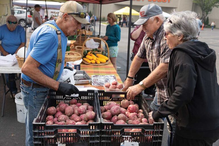 Farmer Leon Overton of Overton Farms, left, sells produce at Twin Falls Farmer's Market which happens on Saturdays on Pole Line Road in Twin Falls, Idaho.