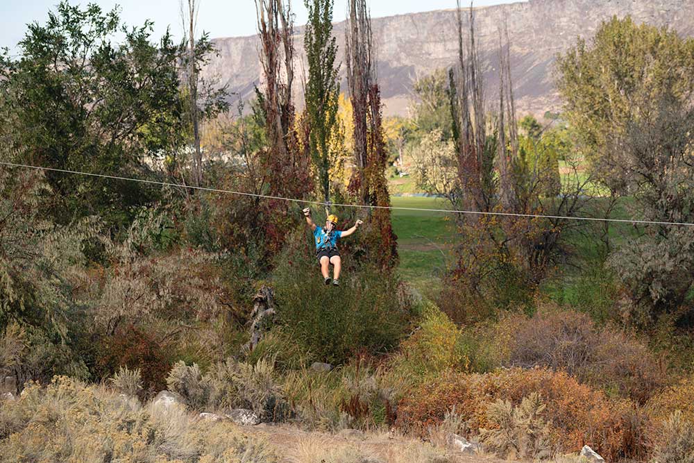Man ziplines in Southern Idaho as part of a AWOL Adventure Sports Zip lining adventure.