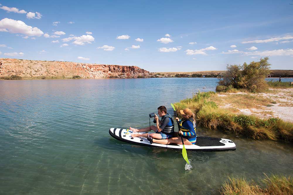 Dionne Fish paddle boards with her son Brody at the Lea Lake area at Bottomless Lake State Park near Roswell.