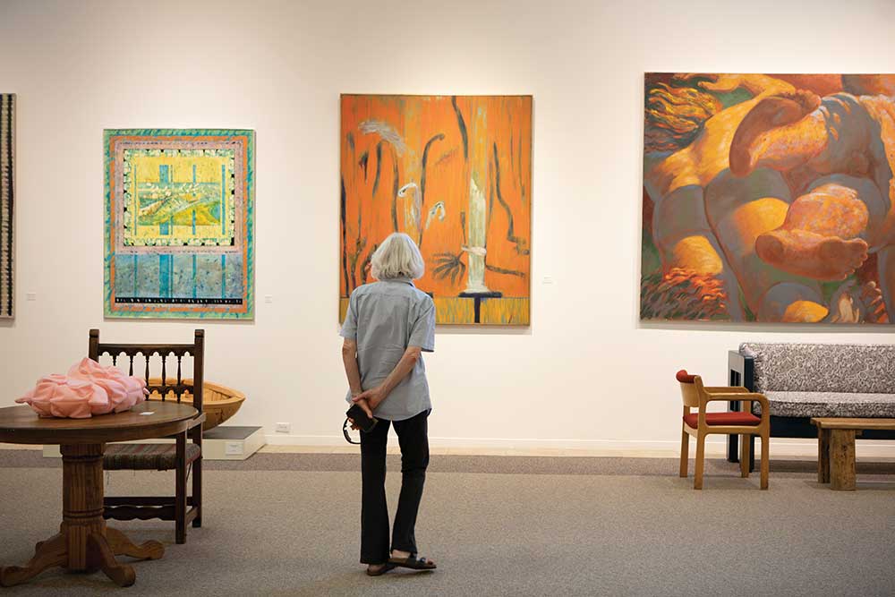 Carol Morris looks at the sculptures and paintings on display at the Anderson Museum of Contemporary Art in Roswell.