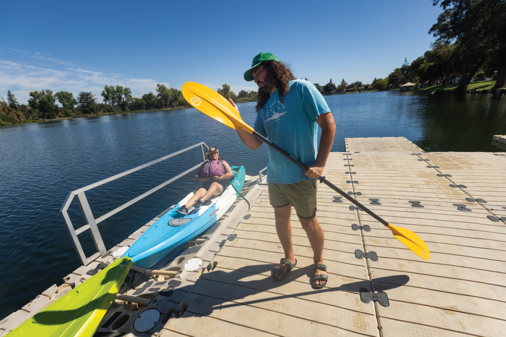 Employees give kayaking tips to visitors at Lodi Boathouse on Lodi Lake in Lodi, California; San Joaquin County water activities