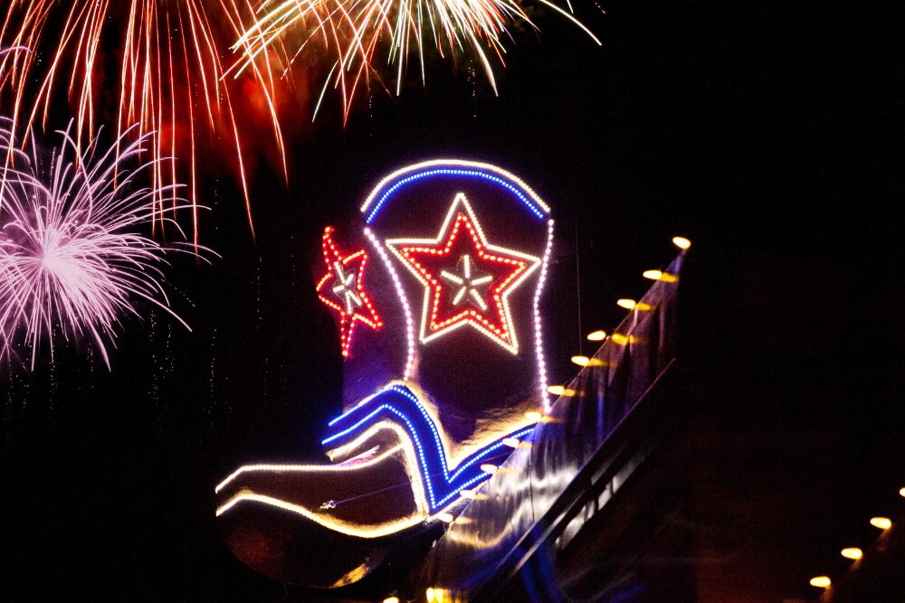 A glowing 6-foot cowboy boot is lowered from The Palace building on new years eve in Prescott, AZ