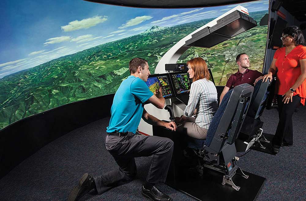 Students gather in the Collins Aerospace Simulation Lab to practice taking flight in Cedar Rapids, IA.
