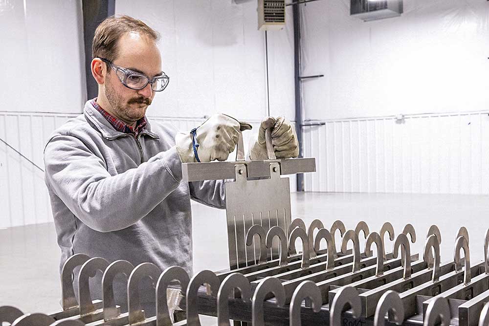 SkyNano’s Stan Hunter selects an electrode to load into the molten salt electrochemical reactor. SkyNano was among the first cohort of Innovation Crossroads in 2017. The company recently opened a facility in Louisville, Tennessee. Credit: Carlos Jones/ORNL, U.S. Dept. of Energy