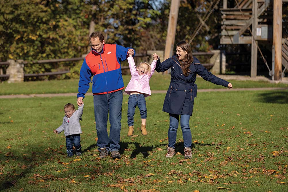 A young family poses for a photos at High Cliff State Park in Wisconsin.