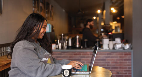 Enya Spicer works on her laptop at Al Banco Coffee in Great Falls, Montana.