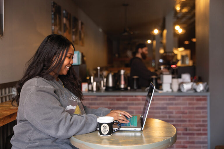Enya Spicer works on her laptop at Al Banco Coffee in Great Falls, Montana.