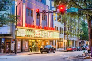 People visit the historic Georgia Theatre at dusk. The venue has featured many prominent acts from the prolific Athens music scene.