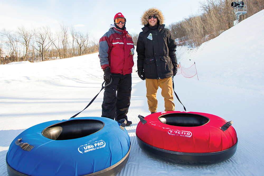 Men with snow tubes pose for a photo at Cascade Mountain in Portage, WI.