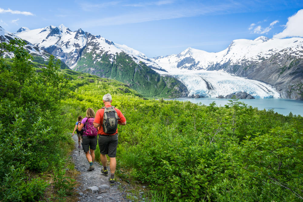 Hikers descend Portage Pass with a view of a glacier in Anchorage, AK. Outdoor adventures are one of the key advantages of living in Anchorage, AK.