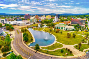 This aerial photo shows downtown Huntsville, AL, with Big Spring International Park and fountain in the foreground, during autumn. Plentiful green spaces help make Huntsville a best place to live in the U.S.