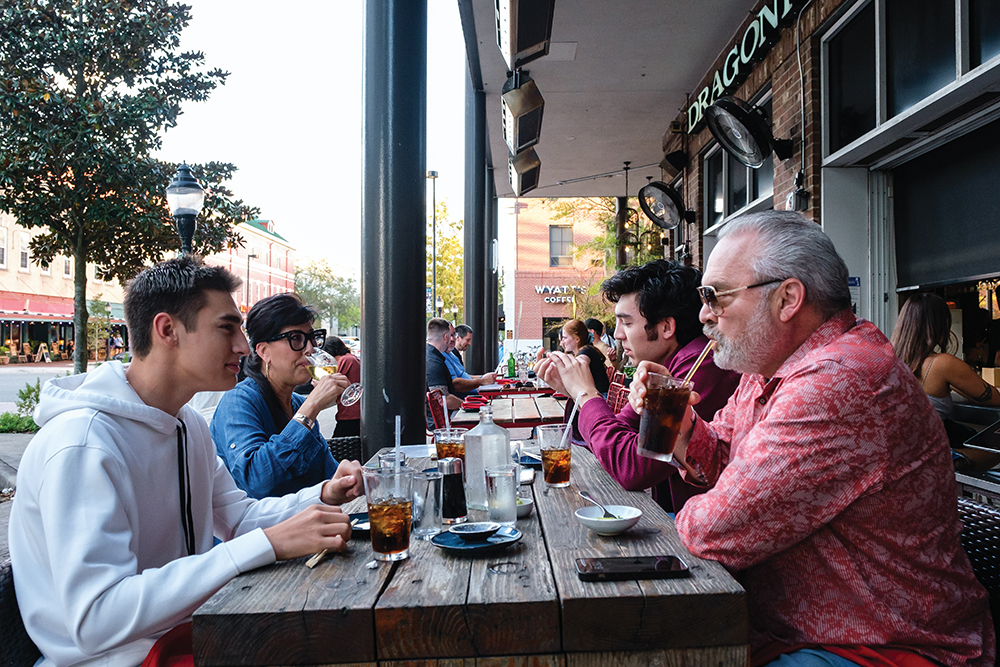 People dine outside at Dragonfly Sushi & Sake Co. in Gainesville, FL.