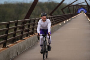 A cyclist rides across The High Trestle Trail Bridge in Madrid, Iowa. The bridge crosses the Des Moines River.