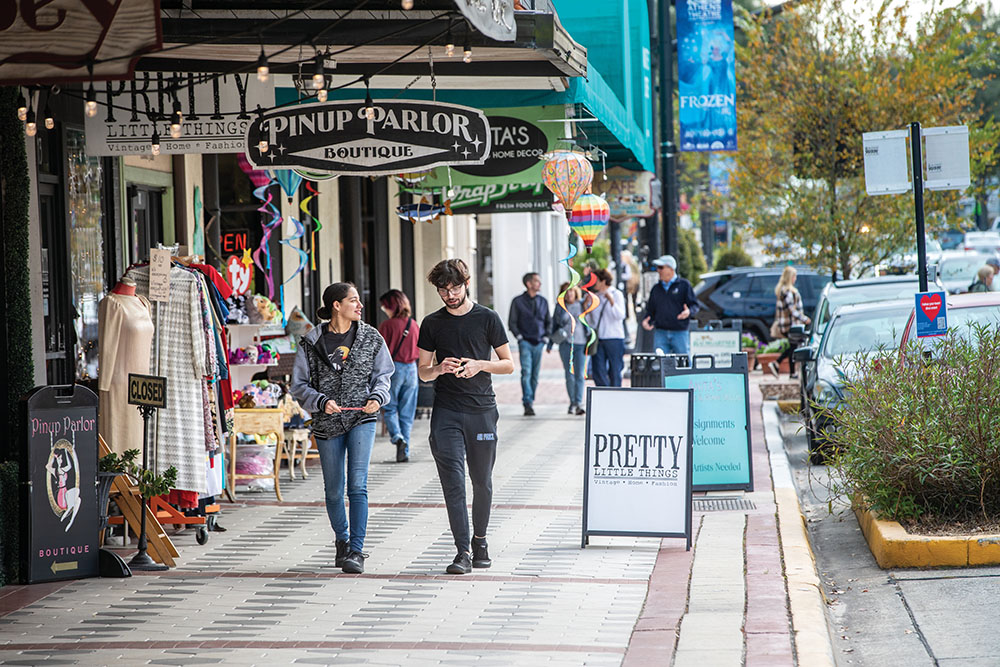 People walk through downtown Deland, FL.