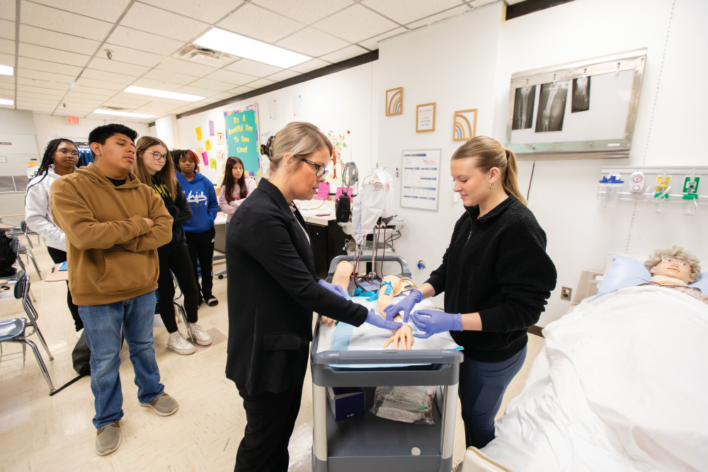 Makayla Brawley, right, practices placing an IV line in a simulated arm with the help from her teacher Alice Morris in one of Springfield High School's Career and Technical Education classes.