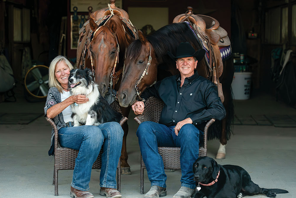 Alaybe Blickle and her husband Matt Livengood of Sweet Pepper Ranch just south of Nampa, ID, pose for a photo with their horses and dogs.
