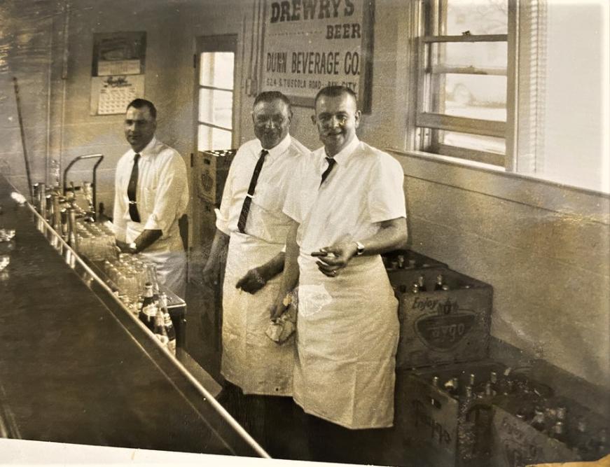 A vintage photo of men making beer