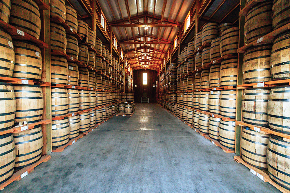Barrels line shelves at Koenig Distillery in Nampa, ID.
