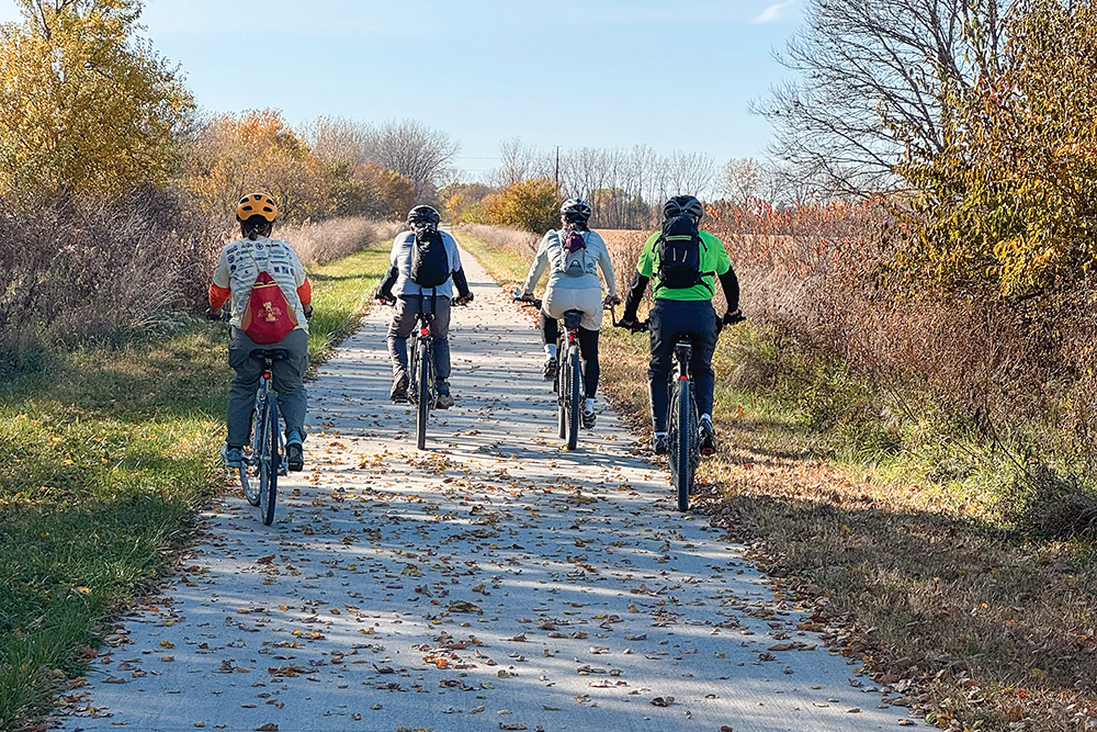 A group of cyclists ride on the Heart of Iowa Nature Trail near Ames, Iowa.