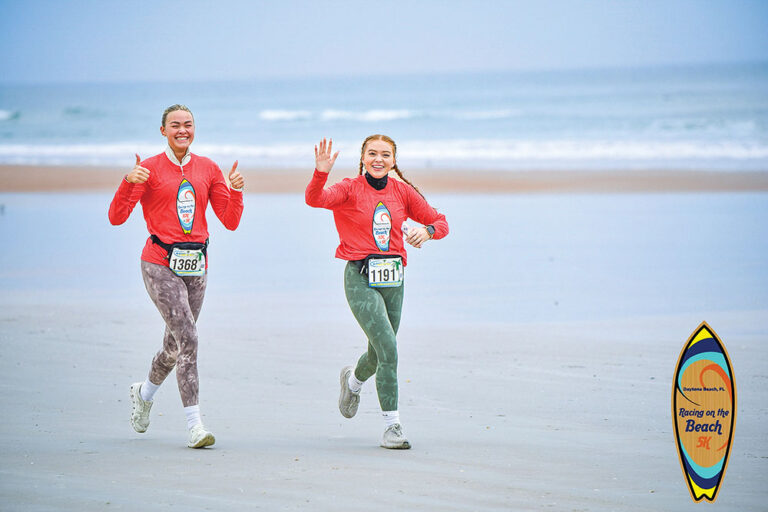 Two young run in the Racing on the Beach 5K in Daytona Beach, FL.