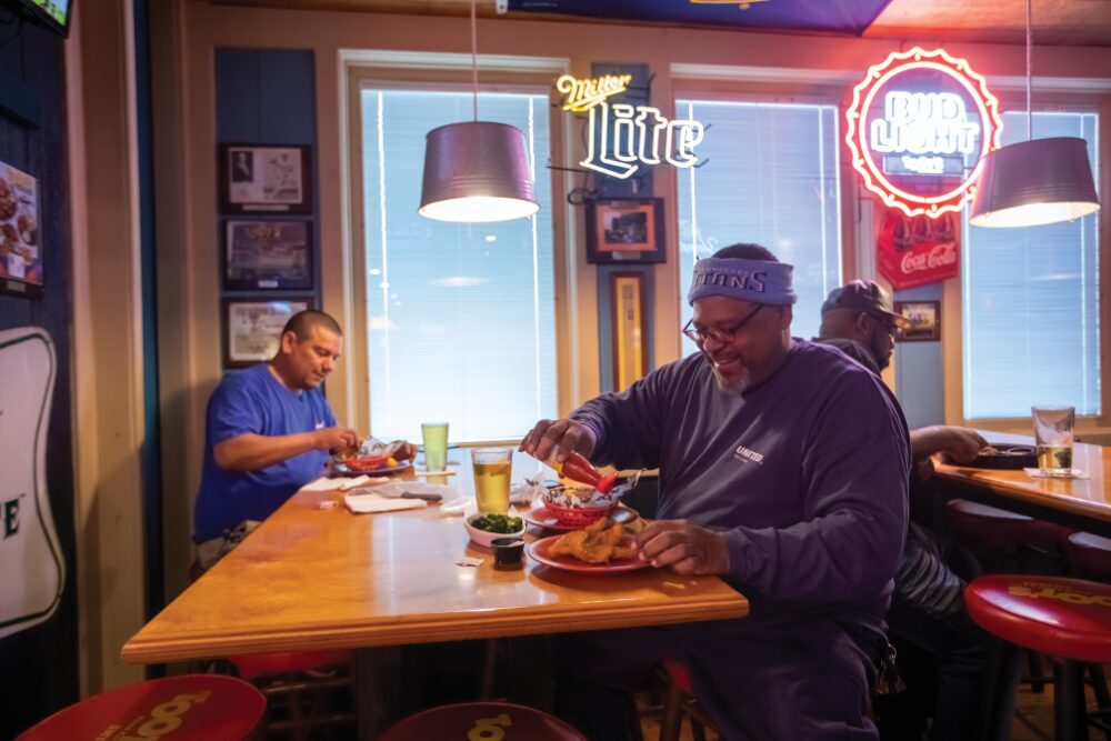Travis Jackson, right, and Angel Quinones enjoy lunch at the Toots location in Smyrna.
