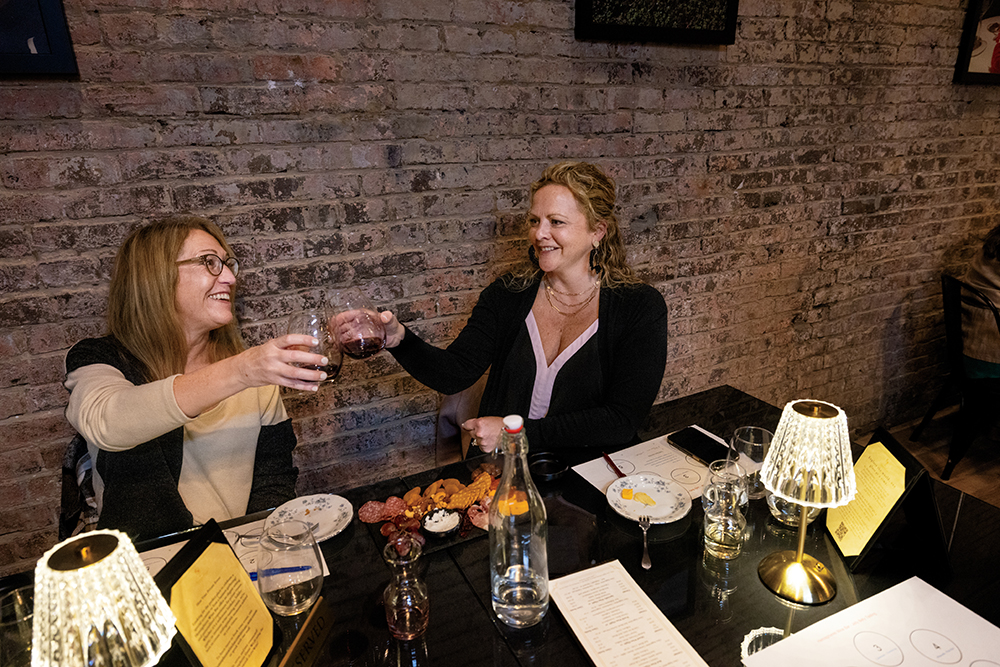 Nicole Barnes, left, and Crystal Turley sample wines during a wine tasing at Hemispheres Wine Bar in downtown Murfreesboro, TN.
