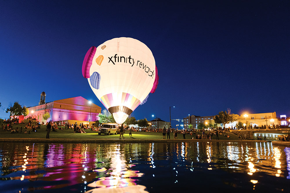 Balloons are inflated on the riverbank downtown just after sunset at the 2024 Pueblo Chili & Frijoles Festival.