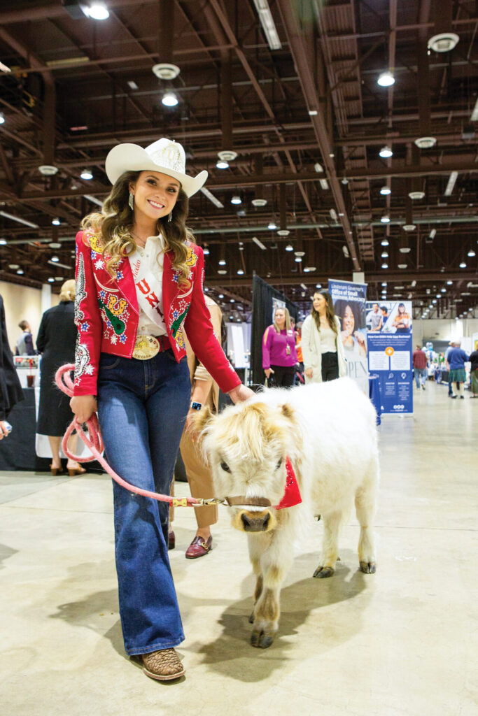 A woman walks a calf on a lead at the annual Business Expo & Career Fair sponsored by the Reno + Sparks Chamber.