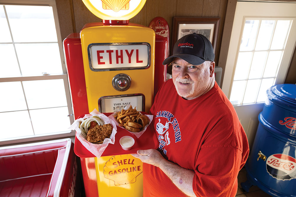 General manager Shane Shafer holds a breaded tenderloin sandwich at Cammack Station in Muncie, Indiana.