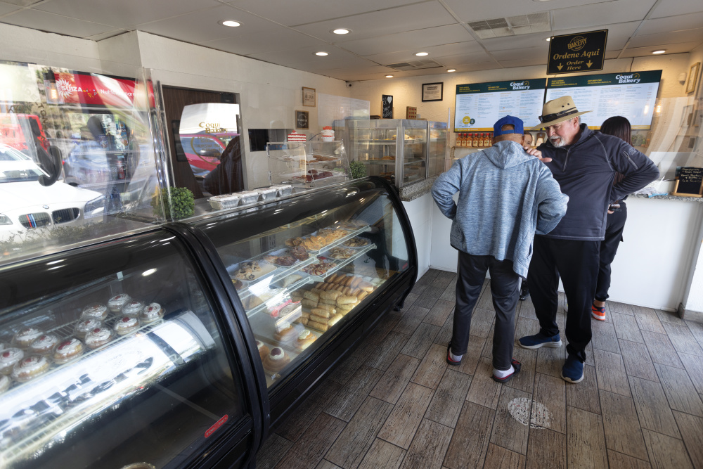 Customers in line for baked goods at El Coqui Bakery in Deltona, Florida.