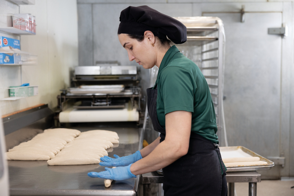 Baking fresh Sobao bread in the kitchen at El Coqui Bakery in Deltona, Florida. 