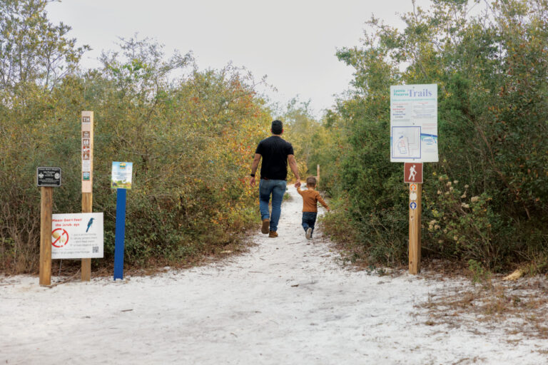Visitors walk the sand trails at Lyonia Environmental Center in Deltona, Florida.