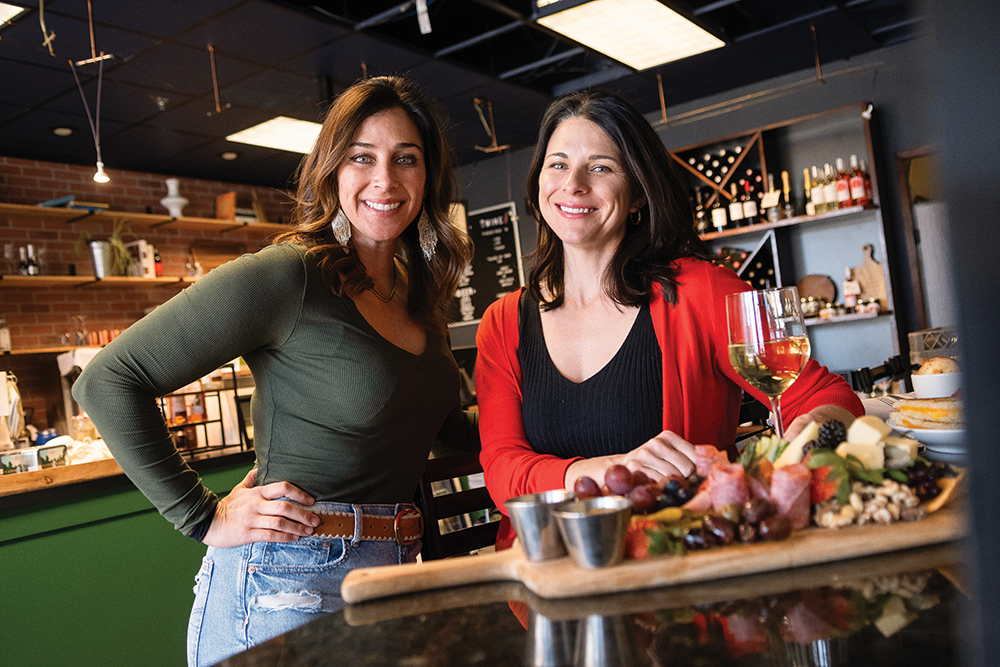 Caitlin Kintop Fletcher, left, and her sister Krista Kintop Phillips, owners of The Cheese Board pose for a photo inside their Midtown location in Reno, NV.