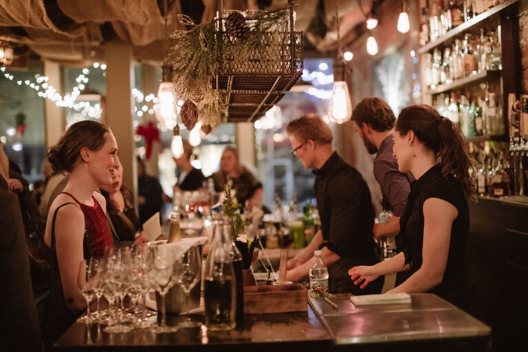 People order drinks from the bar at The Black Cypress restaurant in Pullman, WA.