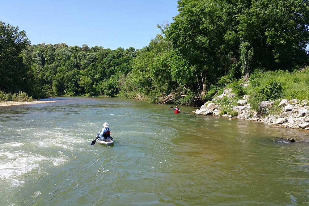 People paddle kayaks along the Crooked Creek Water Trail in Marion County, Arkansas.