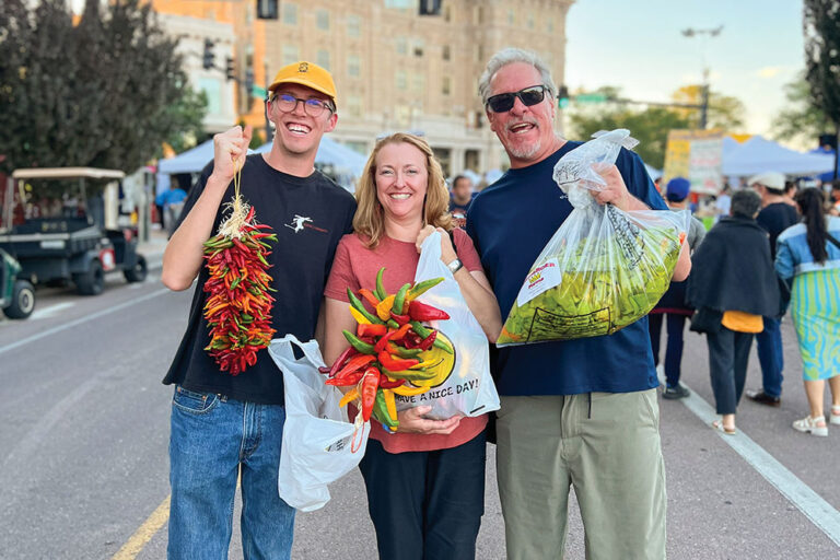 Attendees of the Pueblo Chile & Frijoles Festival show off their chile hauls.