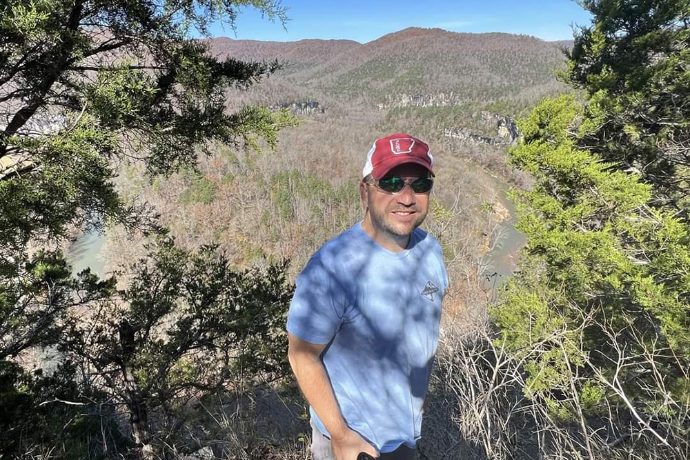 Scott Hallmark poses for a photo while hiking in Arkansas.