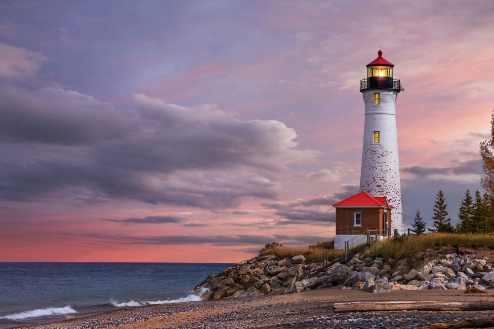 As daylight begins yielding to twilight, The Crisp Point Lighthouse at sunset on Lake Superior, Upper Peninsula, Michigan, USA - A one hour drive from Tahquamenon Falls, mostly dirt roads