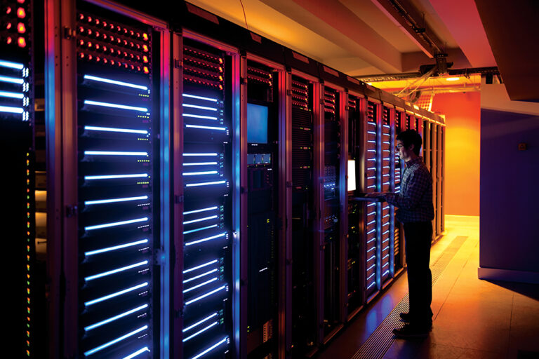 Modern interior of server room in datacenter. IT Engineer in Action Configuring Servers.
