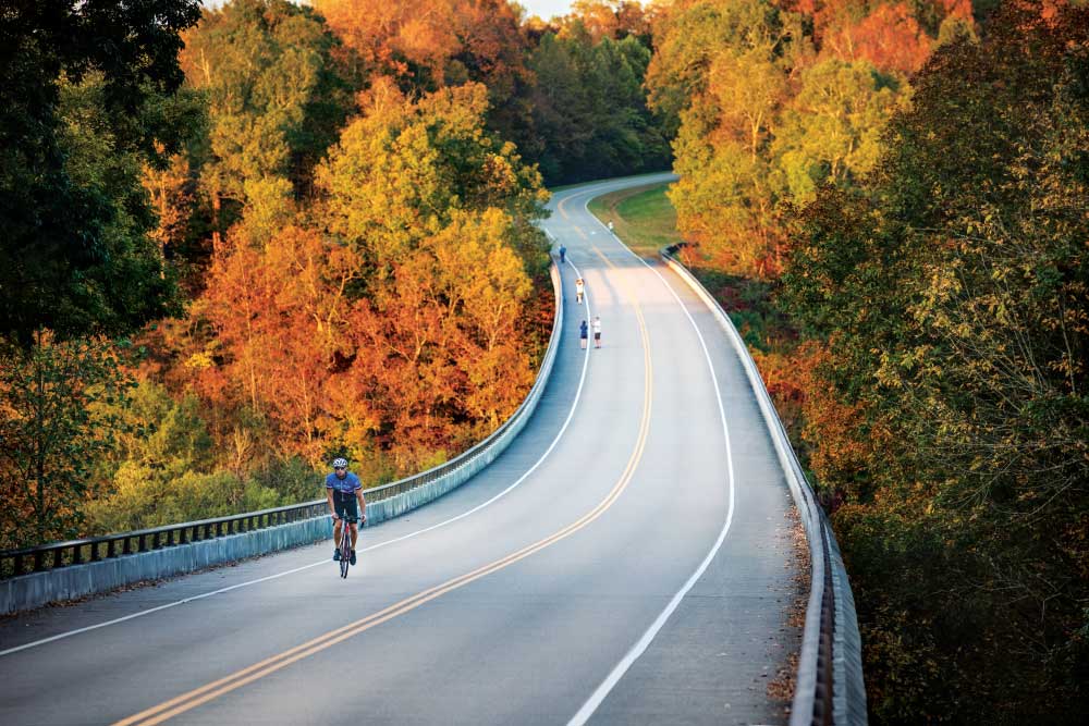 Cyclists ride over the Natchez Trace Parkway Bridge along the Natchez Trace Parkway in Williamson County, Tennessee. November 2020.