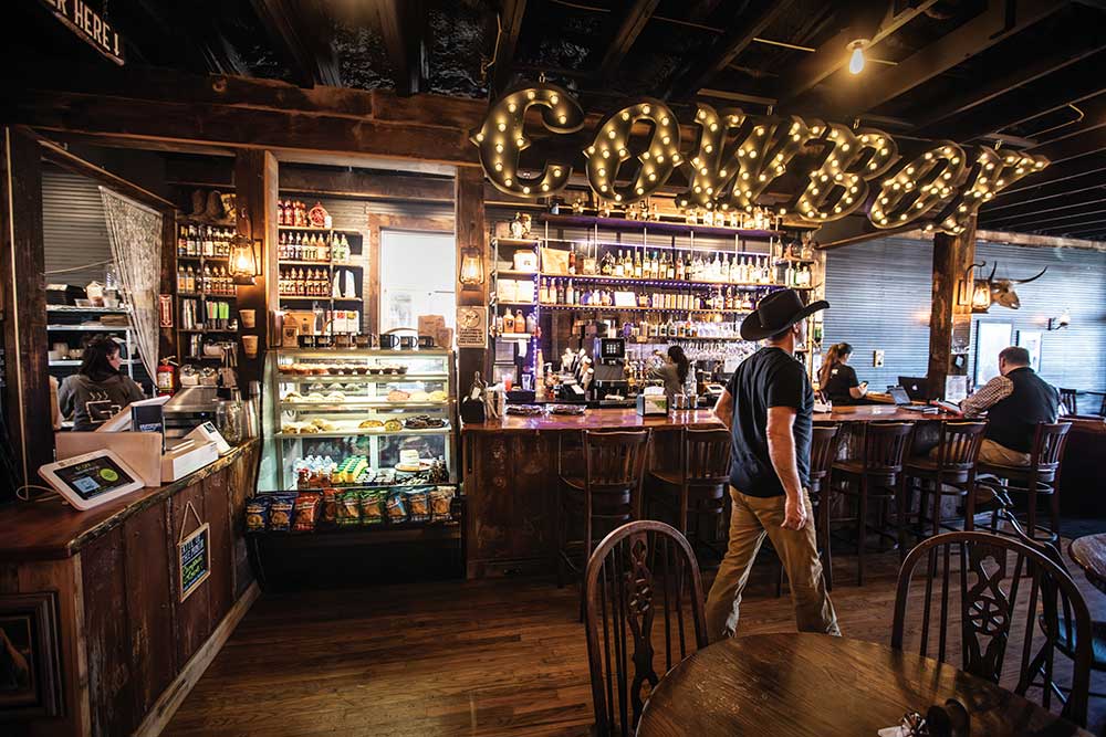 A Cowboy sign lights up above the bar at the Grindstone Cowboy in Eagleville, Tennessee.