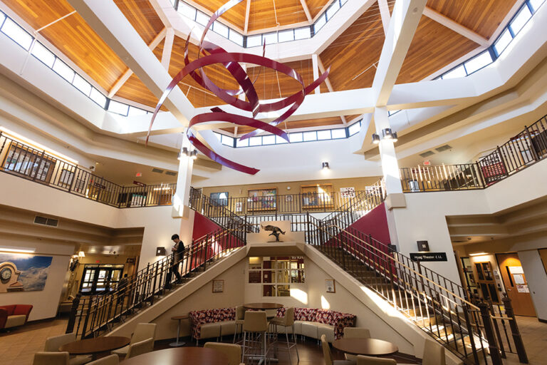 A large red sculpture hangs over the staircase at Dr. Mike Davis Academic Buliding on the campus of Pueblo Community College in Pueblo, Colorado.