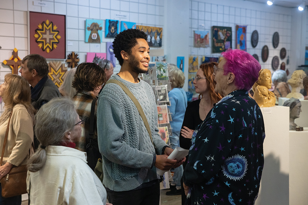 Visitors gather to view art work at Steel City Art Works during First Friday Art Walk in downtown Pueblo, CO.