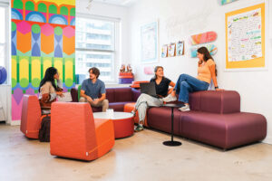 People sit on custom foam furniture created by Fomcore.