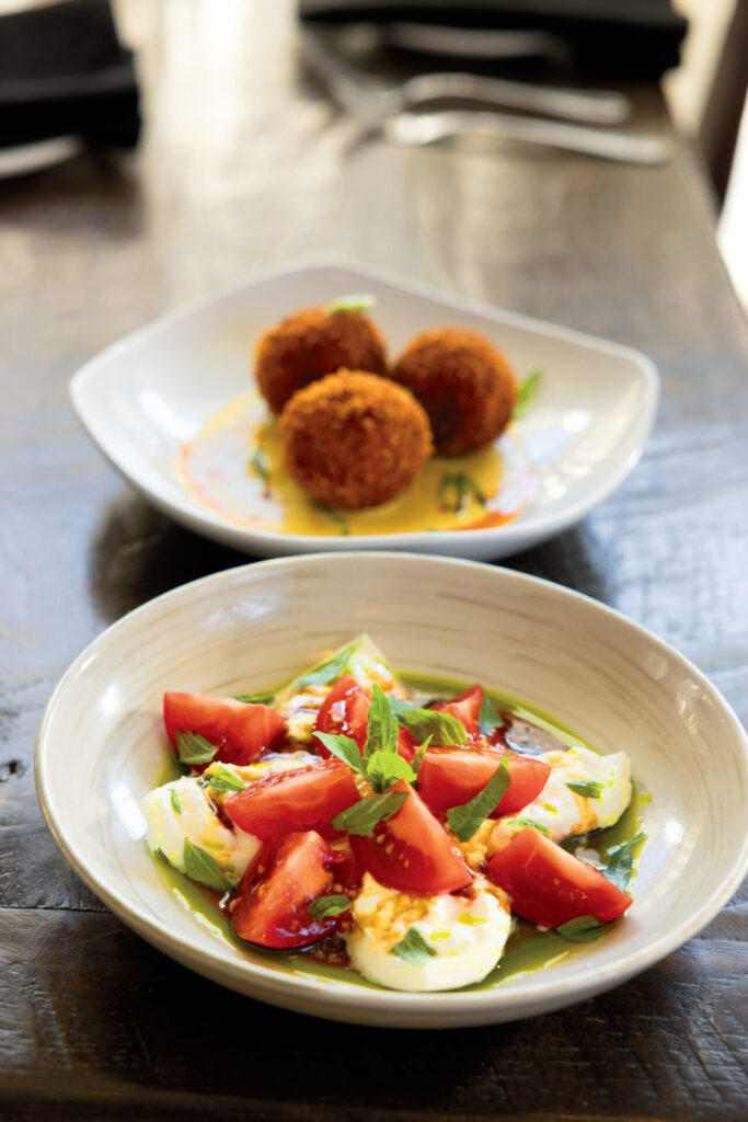 The Burrata Caprese is made with Campari tomatoes, basil oil and aged balsamic reduction and the Arancini is made with Louisiana crawfish, lump crab and jalapeno corn crema at Villa Harlequin in downtown Lake Charles, LA.